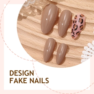Solid nude and leopard print almond fake nails set on a light wood background