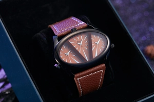 Macro detail of Oulm quartz watch with unique triple dial design and brown leather strap