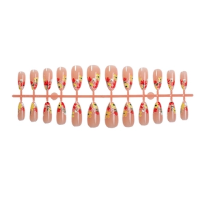 Almond press-on nails with autumn floral patterns and French tips on a nude pink base