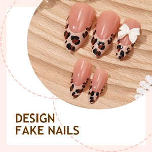 Almond-shaped fake nails with leopard print tips and a white 3D bow on wood display