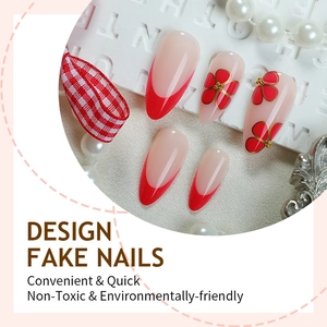 Red French floral press-on nails in long oval shape with elegant gold accents