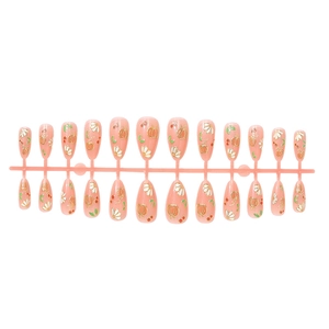 Almond shaped press-on nails with 3D pumpkin and flower designs in peach and gold