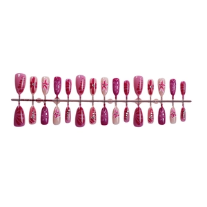 3D press-on nails set featuring pink floral patterns and rhinestones on white backdrop