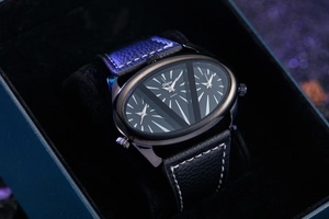 Close-up of Oulm triple time zone watch with black leather strap and contrast stitching