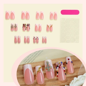 Pink French press-on nails set with gothic crosses, rhinestones and application tools