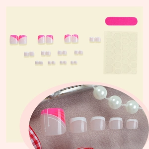 French tip press-on toenails in pink and cream white with geometric pattern design