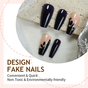 Elegant trapezoid press-on nails featuring dark floral patterns and gold beads