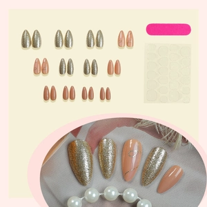 French nude almond press-on nails with champagne gold glitter and elegant art lines
