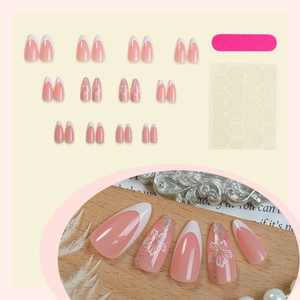 Pink French almond press-on nails with white flower patterns and glitter accents