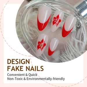 Almond shaped press-on nails with red French tips and floral designs on milky base