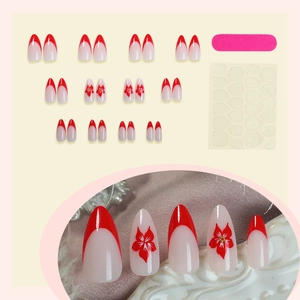 Red French almond press-on nails with white flower patterns and gold stud accents