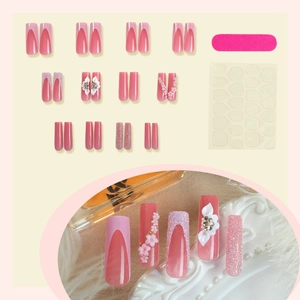 Pink press-on nails set with 3D floral accents and glitter finish with nail file