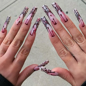Halloween press on nails with spider web patterns and blood drip design on long coffins