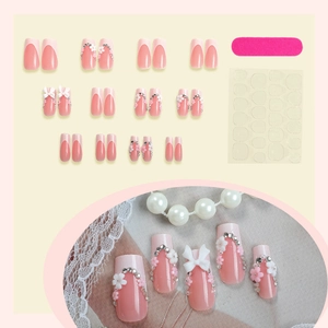 Pink and white press-on nail set with 3D bows, pearls, and file tool included