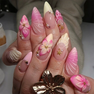 3D ocean-themed press-on nails with pink flowers, sea shells, and pearls stiletto shape