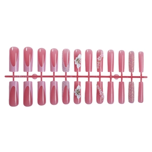 Pink press-on nails set with 3D floral accents, glitter finish, and French tip designs