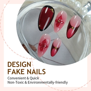 Almond blush press-on nails with red flowers and gold beads on pearl background