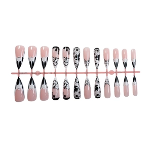 Halloween press-on nails featuring pumpkin, bat, and spider web designs on pink base