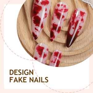 Halloween stiletto fake nails with red blood marble design on wooden tray