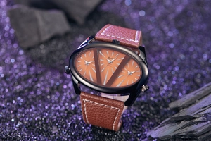 Close-up of Oulm quartz watch with three orange dials and brown leather strap on dark background
