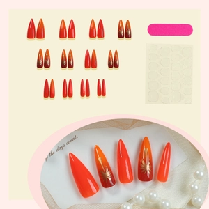 Orange gradient press-on nails with gold palm tree art, nail file, and adhesive tabs