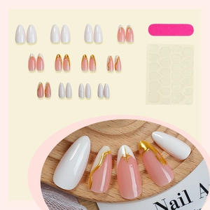 French almond press-on nails with white pink gold foil design and tool kit
