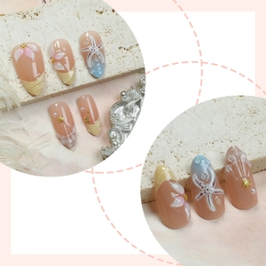 Nude pink press-on nails with 3D starfish shells and floral sea-themed pearl designs