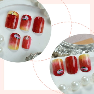 Short square red apple gradient press-on nails with fruit label design on white tray
