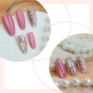 Cat eye press-on nails with 3D butterfly art on pink and pearly white almond tips