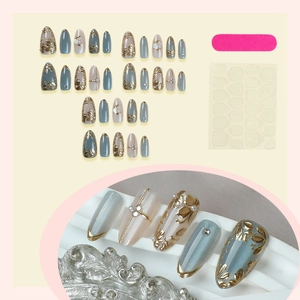 Press-on nails featuring golden leaf cat-eye almond design with 3D floral accents