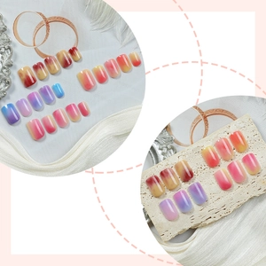 Short square gradient press-on nails set with colorful ombre finish on luxury background