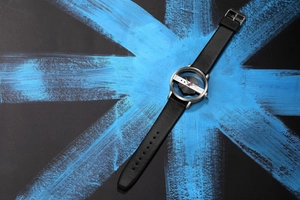 Detail view of the hollow transparent dial and leather strap of a quartz watch