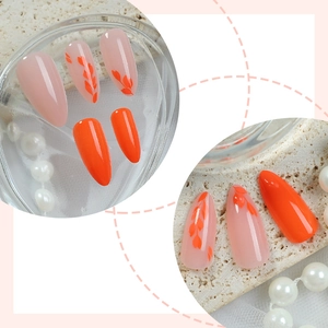French orange fake nails with leaf patterns and elegant almond shape design
