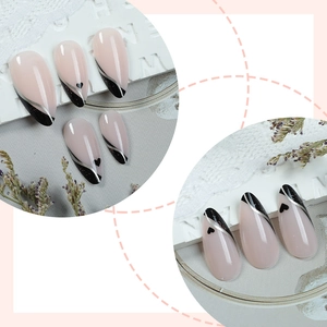 French almond press-on nails with heart patterns and black stripes in elegant nude pink