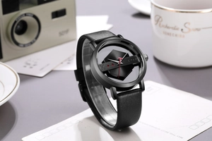 Minimalist TOMI watch with hollow transparent dial and black leather strap in lifestyle setting
