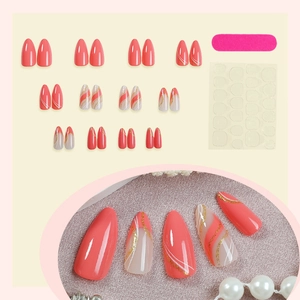 French almond fake nails with coral orange lines and gold glitter sparkling finish