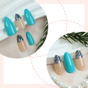 Blue almond fake nails with floral patterns and gold glitter accents in display