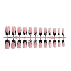 24-piece press-on nails with black French tips, champagne floral accents and glitter