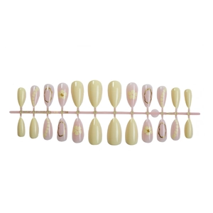 Almond-shaped press on nails featuring delicate white flowers and golden wire designs