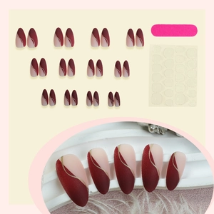 Almond press on nails with matte burgundy design, nude panels and gold wave lines