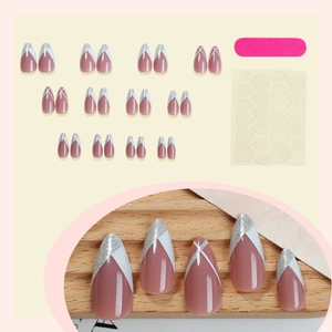 French almond press-on nails with pink base, silver glitter tips and 24pc tool kit