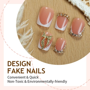 Sparkly white French tip press-on nails with golden butterflies and champagne rhinestones