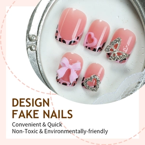 Pink leopard print press-on nails with 3D bows and rhinestone butterfly accents