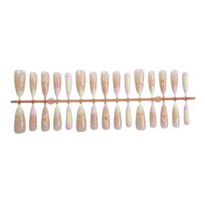 Long coffin press-on nails with pink gradient and 3D floral design on white background