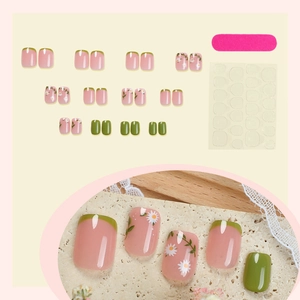 Fresh pink and green press-on nails set with daisy patterns and manicure tools