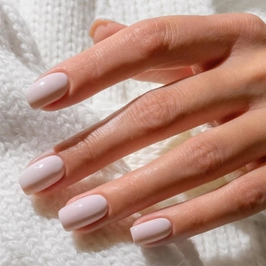 Glossy light pink marble press-on nails on square round shape with sweater background