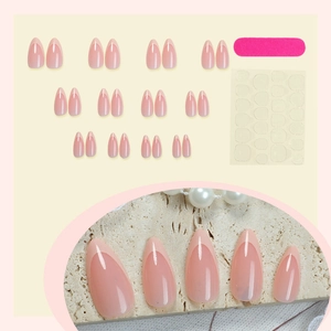 French almond press-on nails set in nude pink jelly tone with pearls and tools