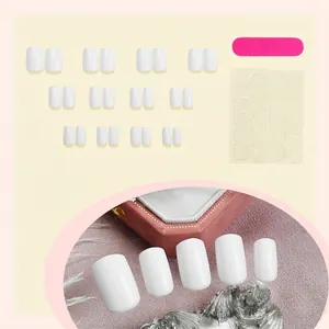 Elegant white short square marble press-on nails set with tools on a soft pink background
