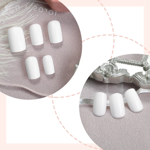 Elegant white marble press-on nails set with glossy finish on soft pink silk background