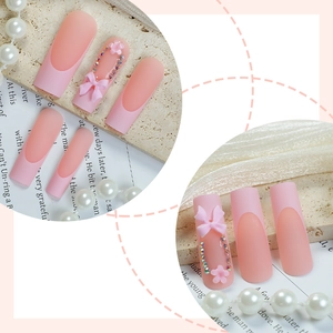 Matte pink coffin press-on nails with 3D resin bows, rhinestones and floral accents